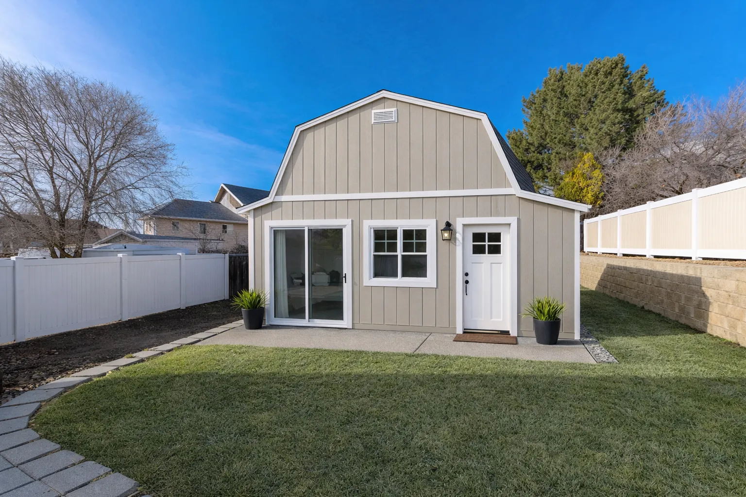 New detached backyard guest house ADU construction completed by professional builders in Los Angeles featuring modern siding and private residential access